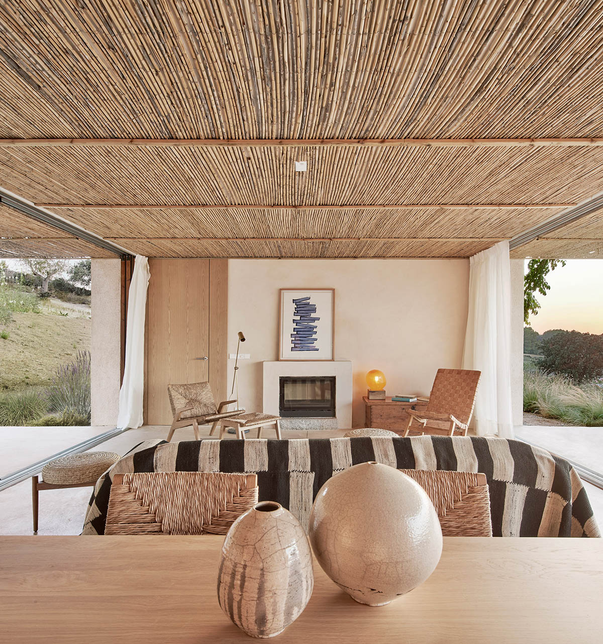 OHLAB's rural villa in Mallorca allows guests to frame natural surrounding under wattle pergola