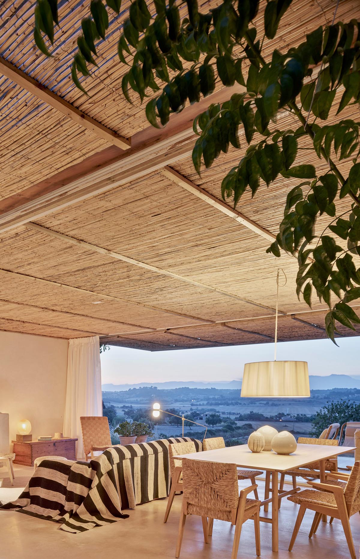 OHLAB's rural villa in Mallorca allows guests to frame natural surrounding under wattle pergola