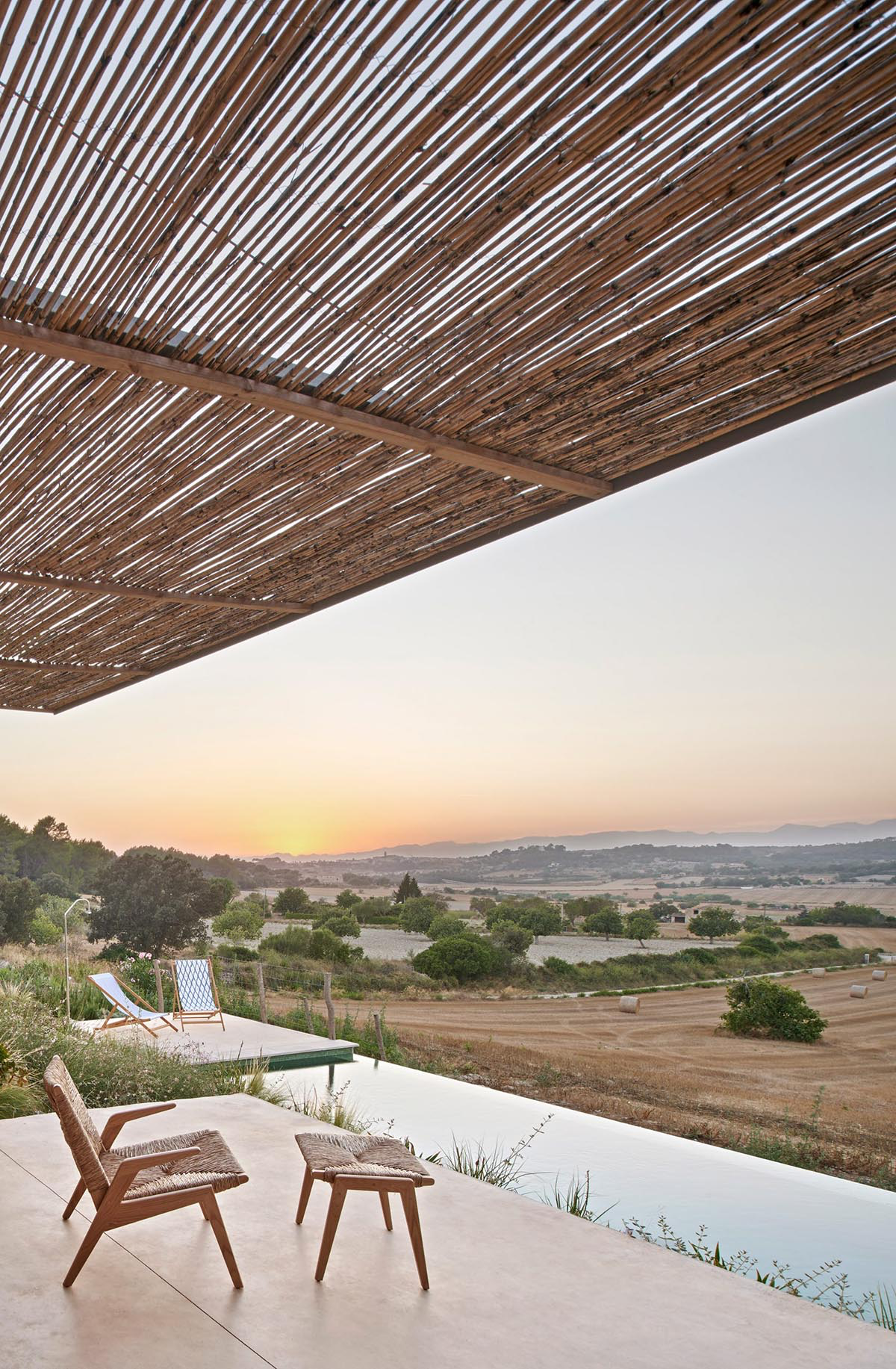 OHLAB's rural villa in Mallorca allows guests to frame natural surrounding under wattle pergola