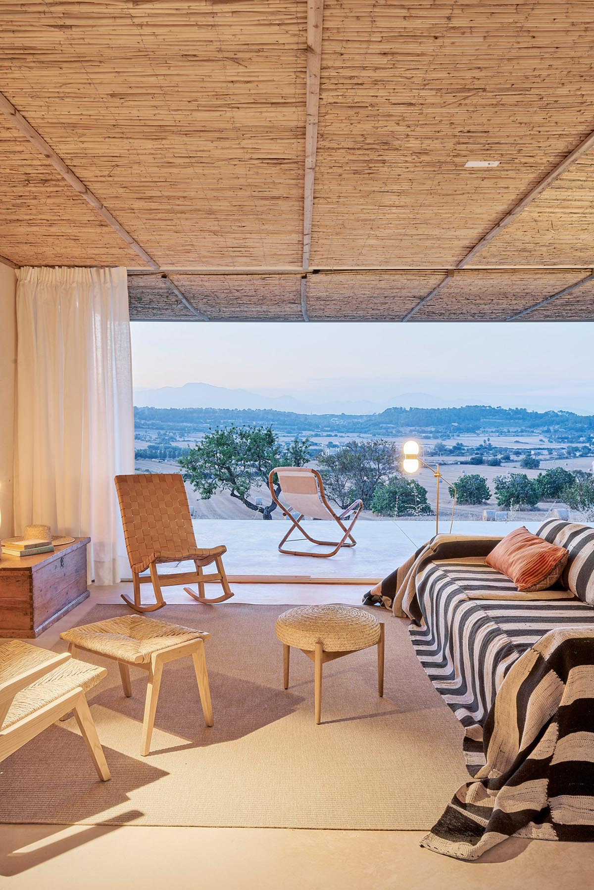 OHLAB's rural villa in Mallorca allows guests to frame natural surrounding under wattle pergola