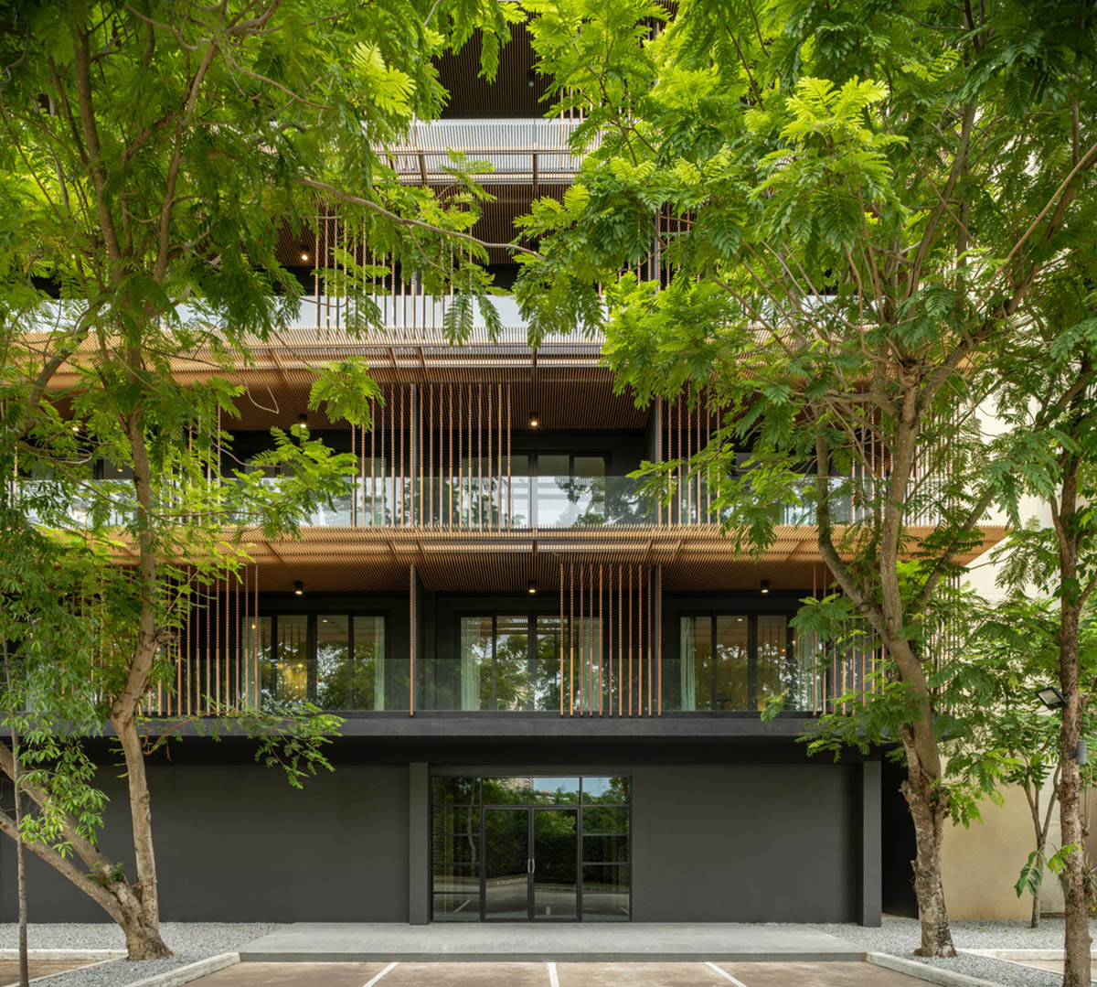 ACA Architects combines vertical timber screens with cantilevered aluminum screens for Thai resort