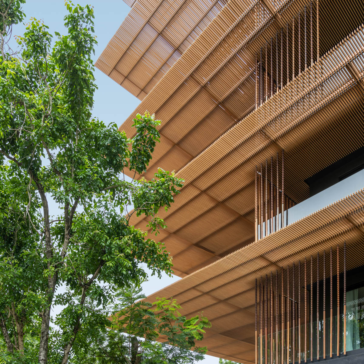 ACA Architects combines vertical timber screens with cantilevered aluminum screens for Thai resort