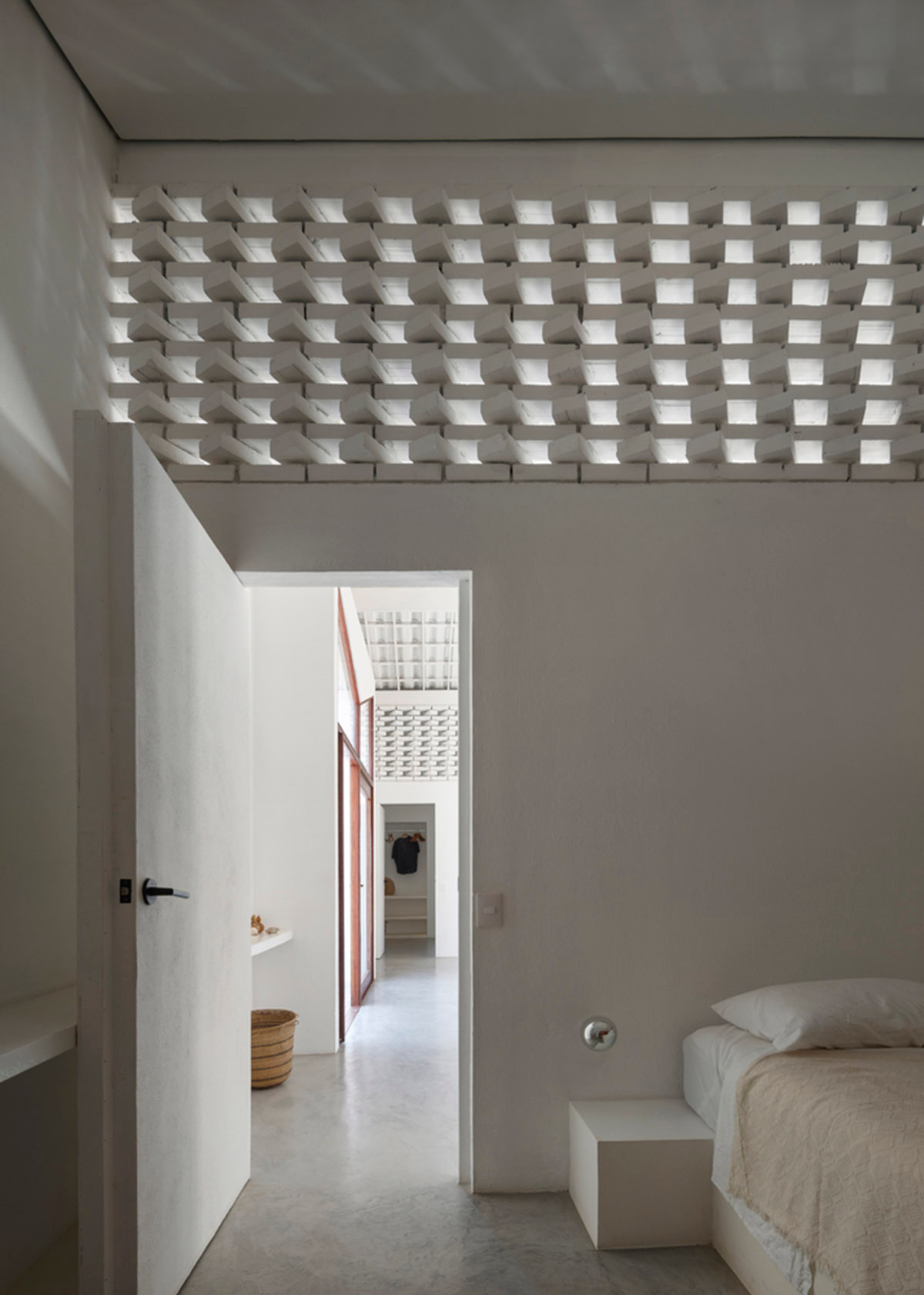 Two identical all-white volumes form this house by Atelier Branco Arquitetura on a flat landscape