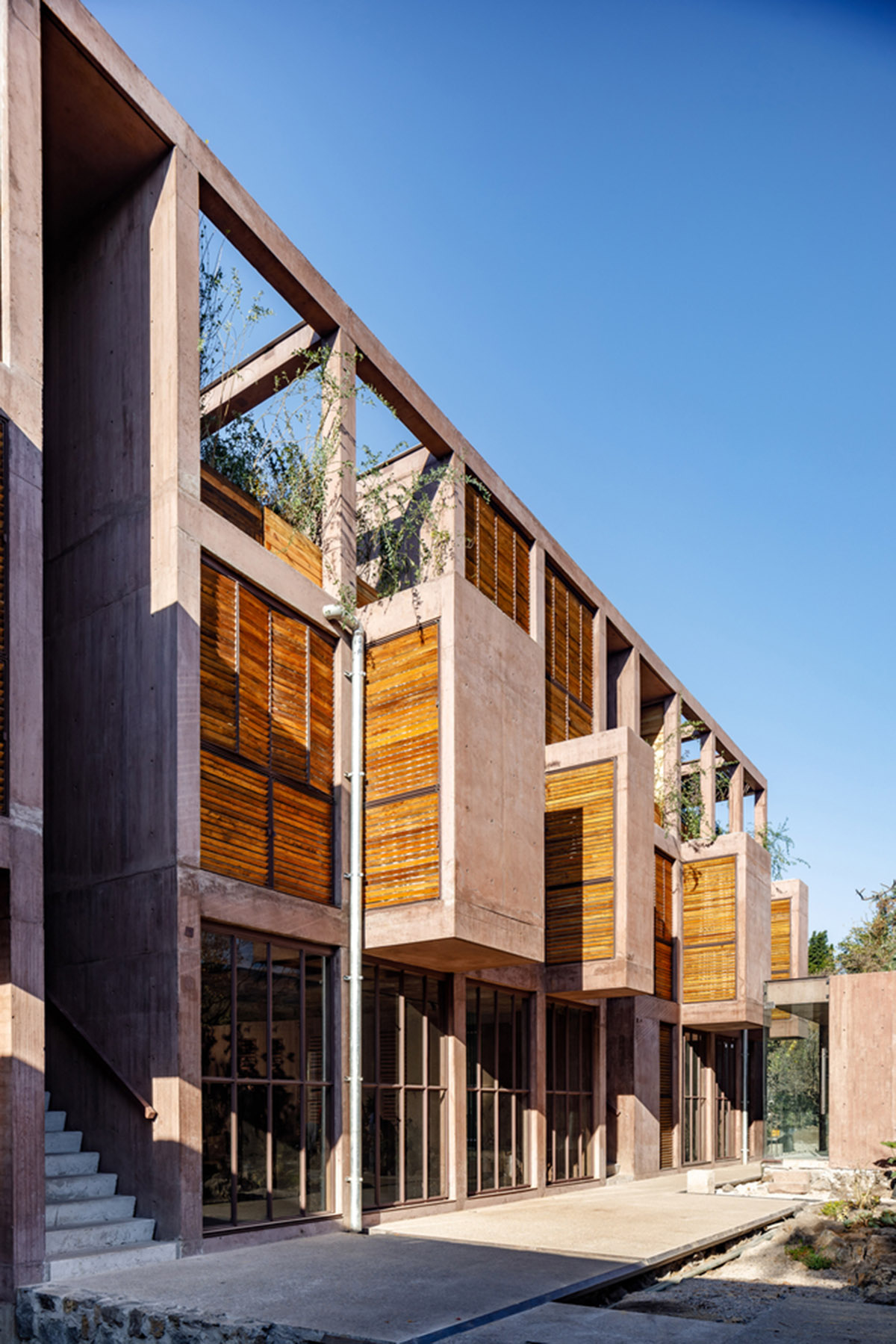 This gridded hotel made from pigmented concrete and volcanic stone sits on rugged terrain in Mexico