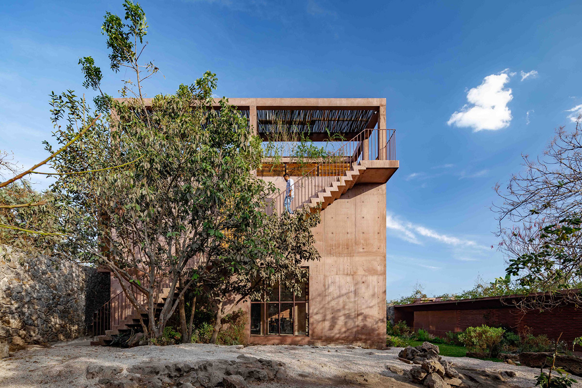 This gridded hotel made from pigmented concrete and volcanic stone sits on rugged terrain in Mexico