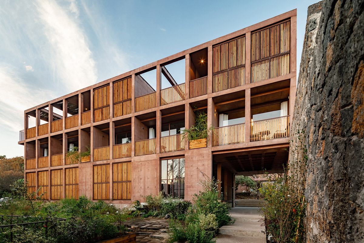 This gridded hotel made from pigmented concrete and volcanic stone sits on rugged terrain in Mexico