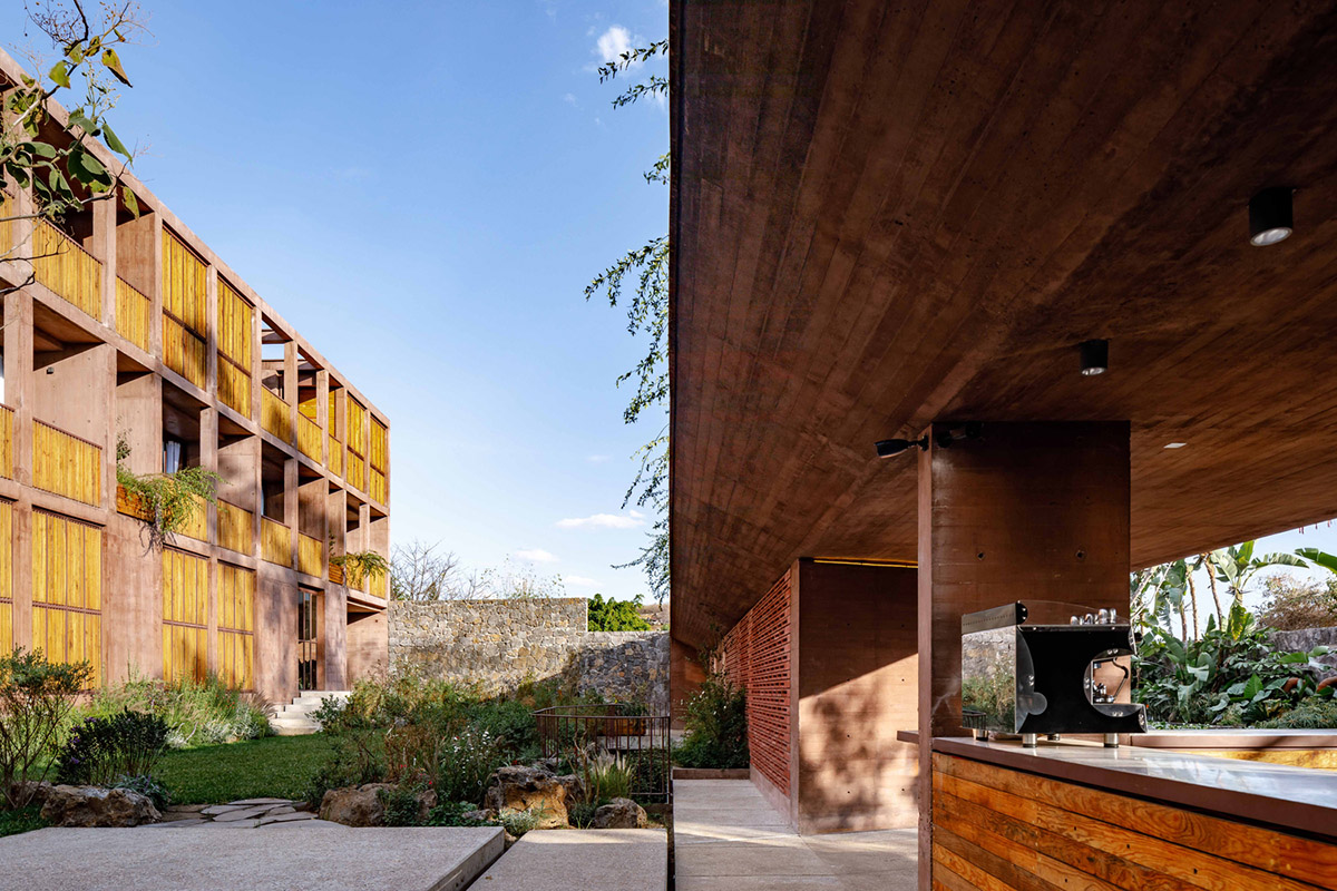 This gridded hotel made from pigmented concrete and volcanic stone sits on rugged terrain in Mexico