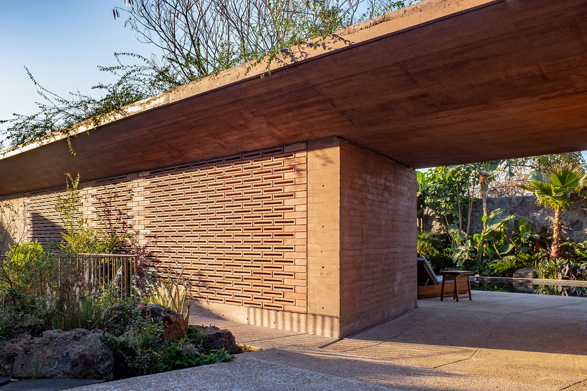 This gridded hotel made from pigmented concrete and volcanic stone sits on rugged terrain in Mexico