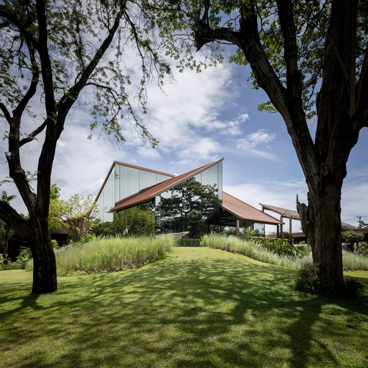 NITAPROW designed Patom Cafe with four segmented roof and thatched-roof walkway in Thailand
