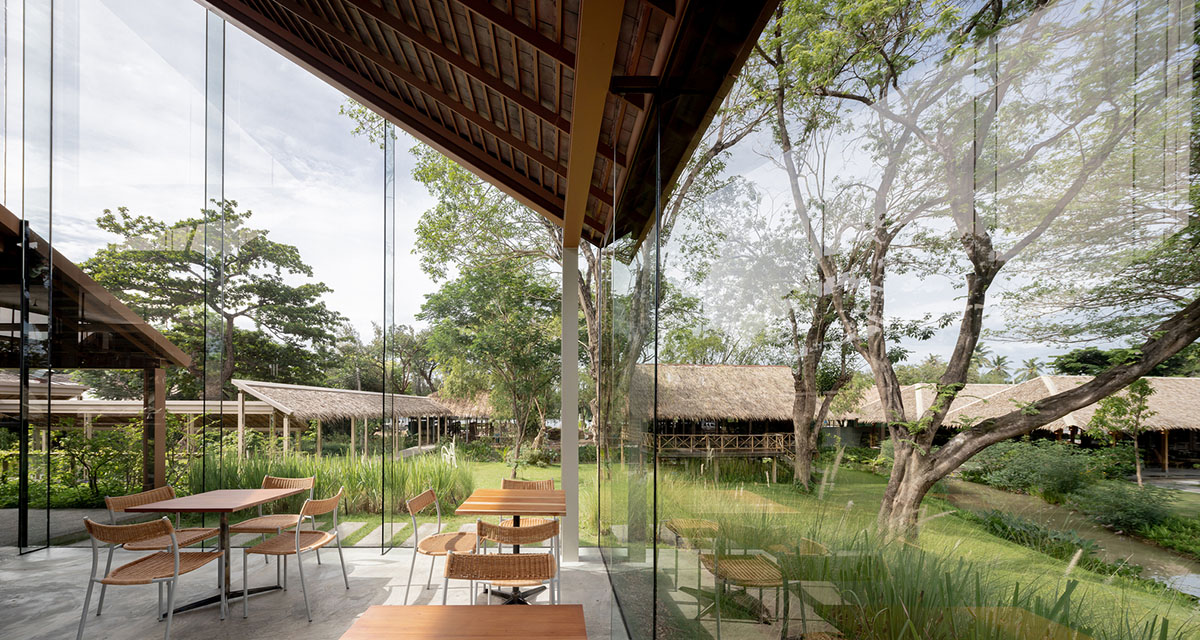 NITAPROW designed Patom Cafe with four segmented roof and thatched-roof walkway in Thailand