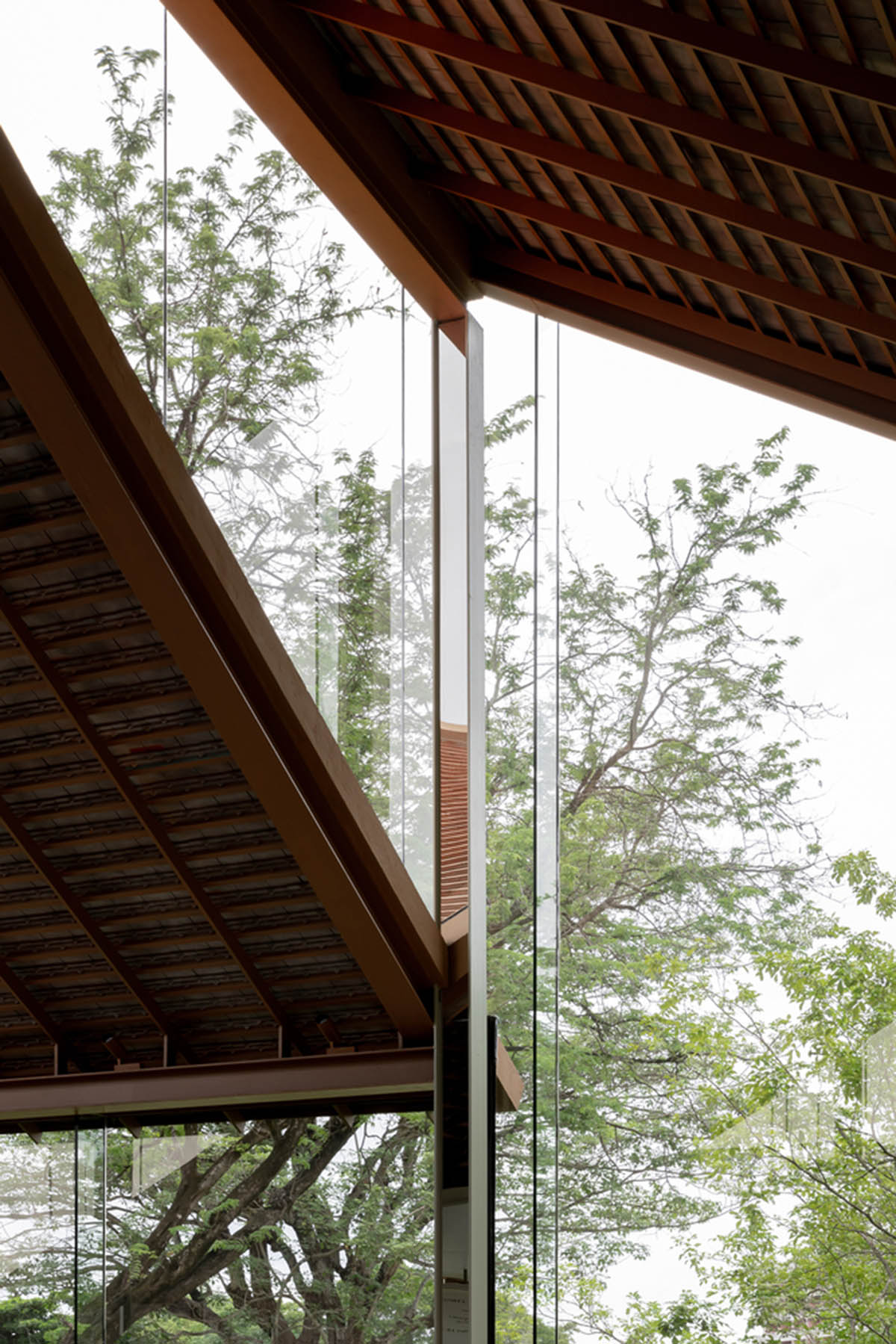 NITAPROW designed Patom Cafe with four segmented roof and thatched-roof walkway in Thailand