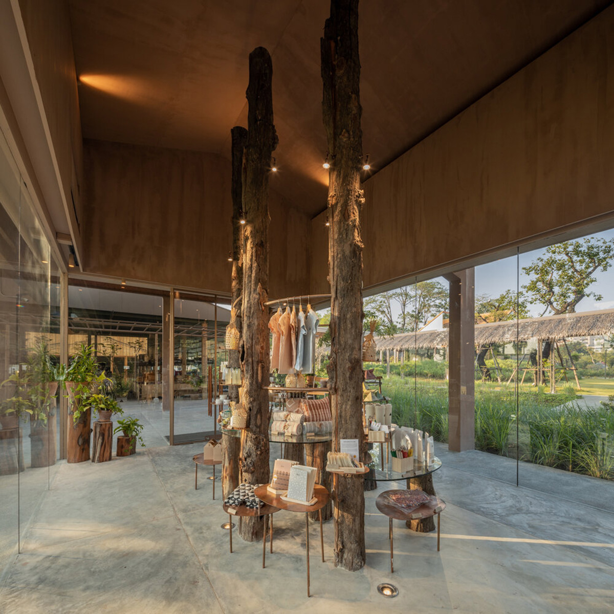 NITAPROW designed Patom Cafe with four segmented roof and thatched-roof walkway in Thailand