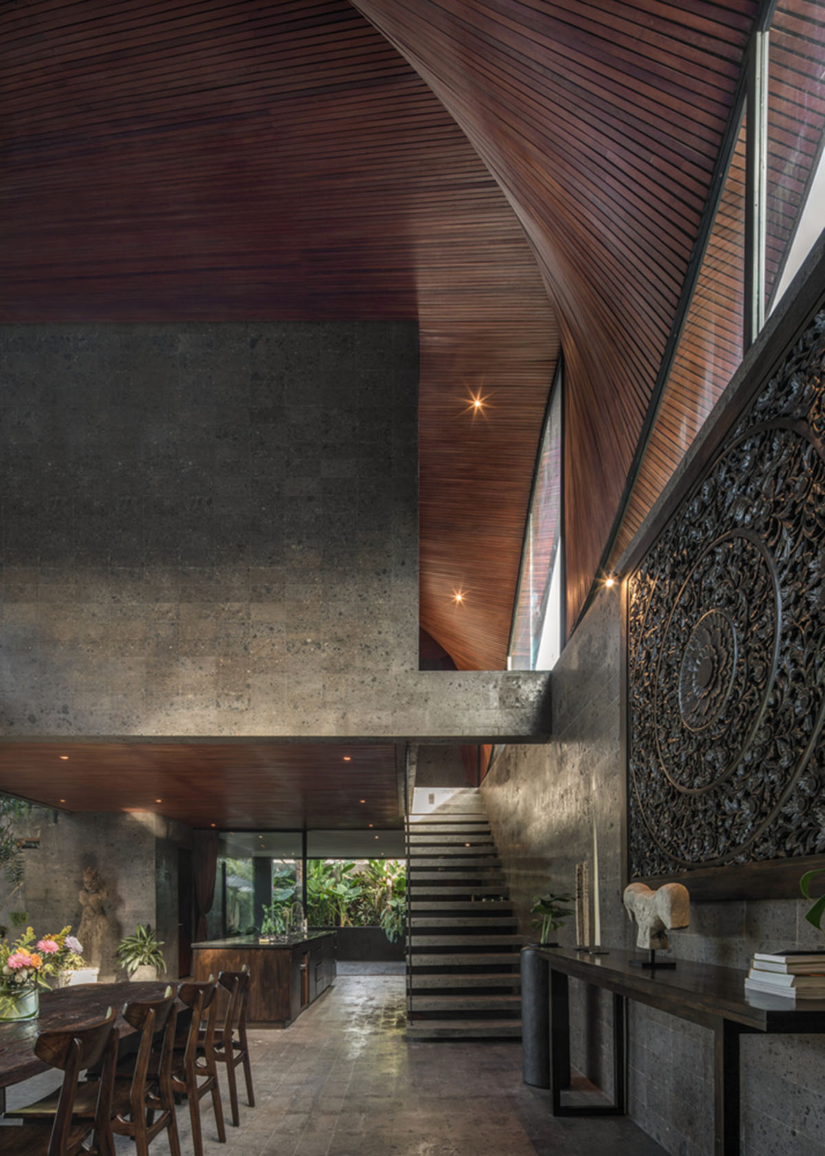 Twisted roof becomes walls and facade in Alpha House designed by Alexis Dornier in Bali