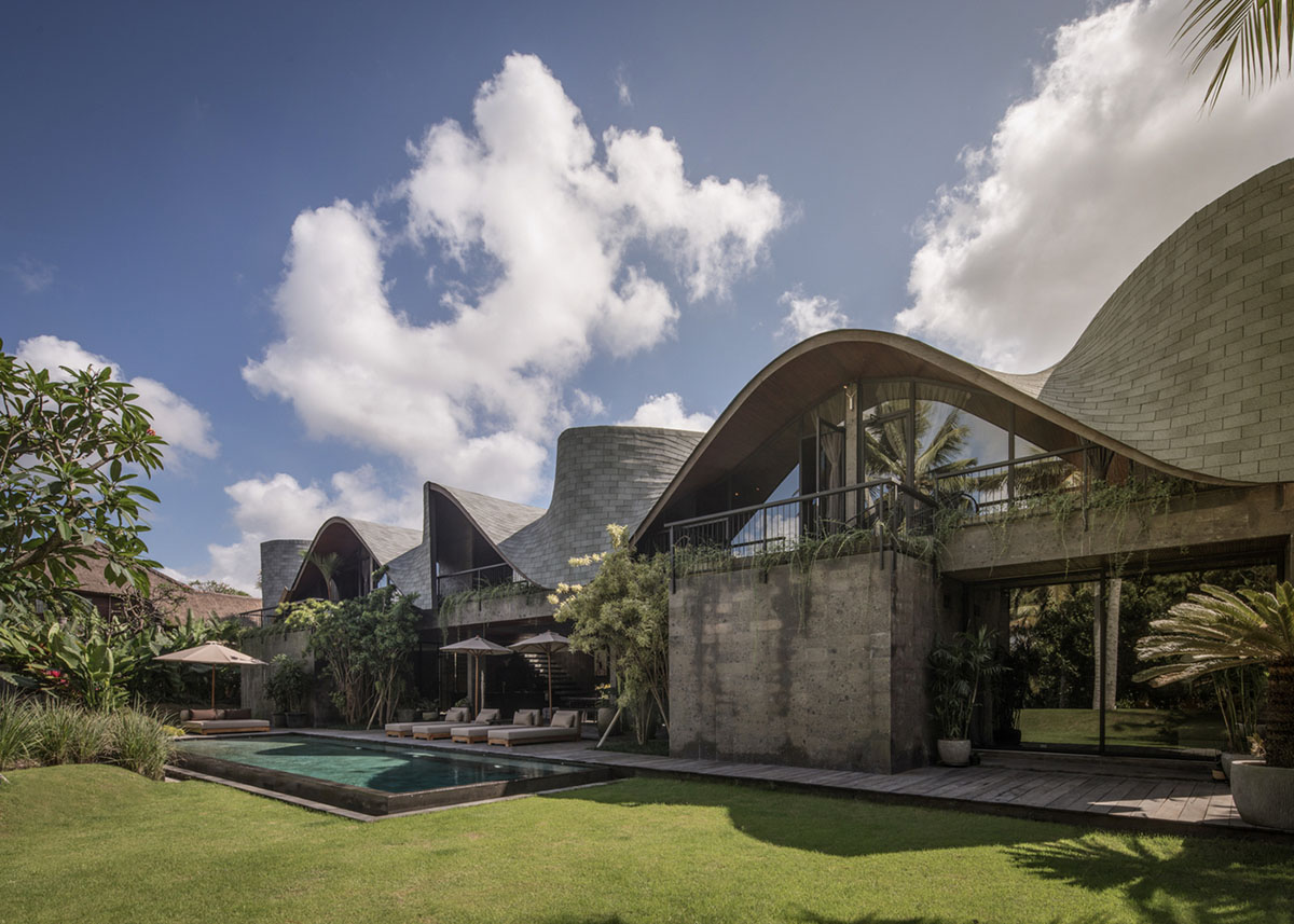 Twisted roof becomes walls and facade in Alpha House designed by Alexis Dornier in Bali