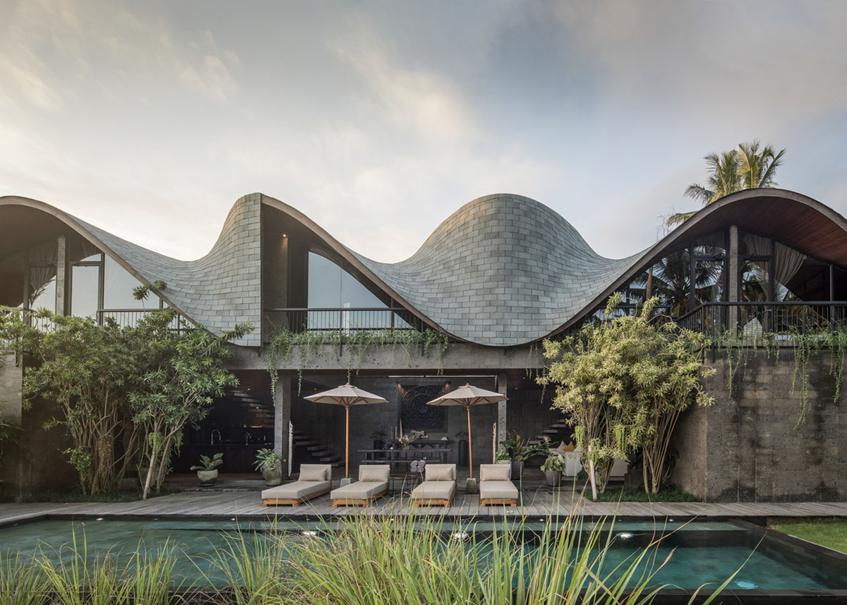 Twisted roof becomes walls and facade in Alpha House designed by Alexis Dornier in Bali