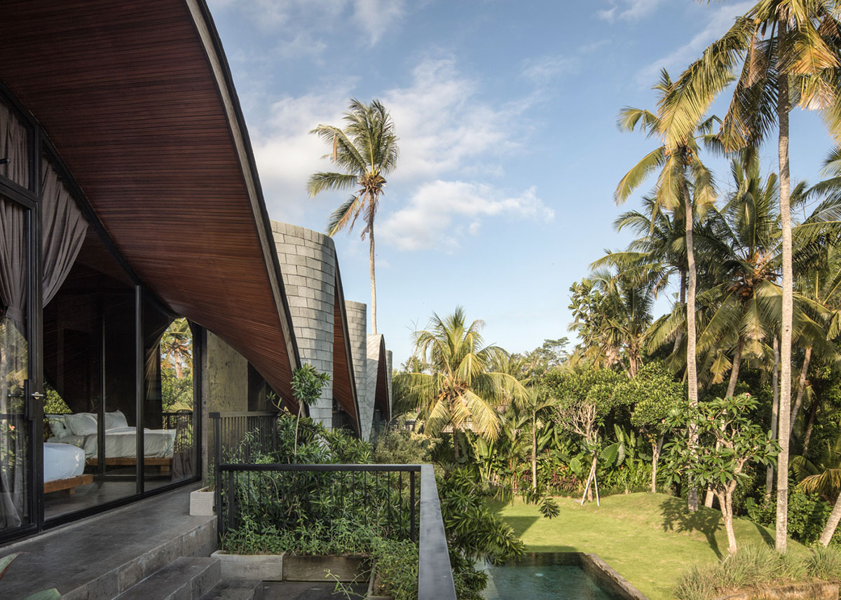 Twisted roof becomes walls and facade in Alpha House designed by Alexis Dornier in Bali