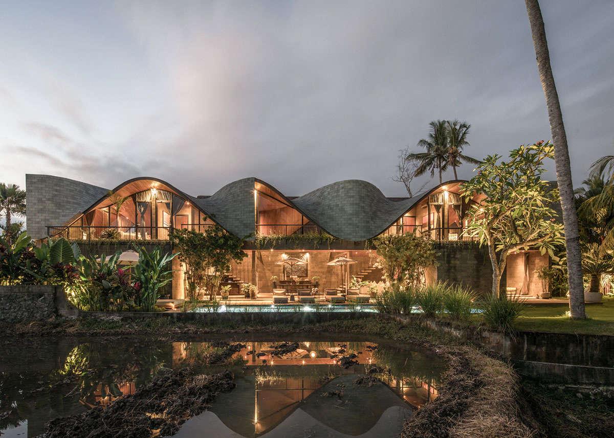 Twisted roof becomes walls and facade in Alpha House designed by Alexis Dornier in Bali