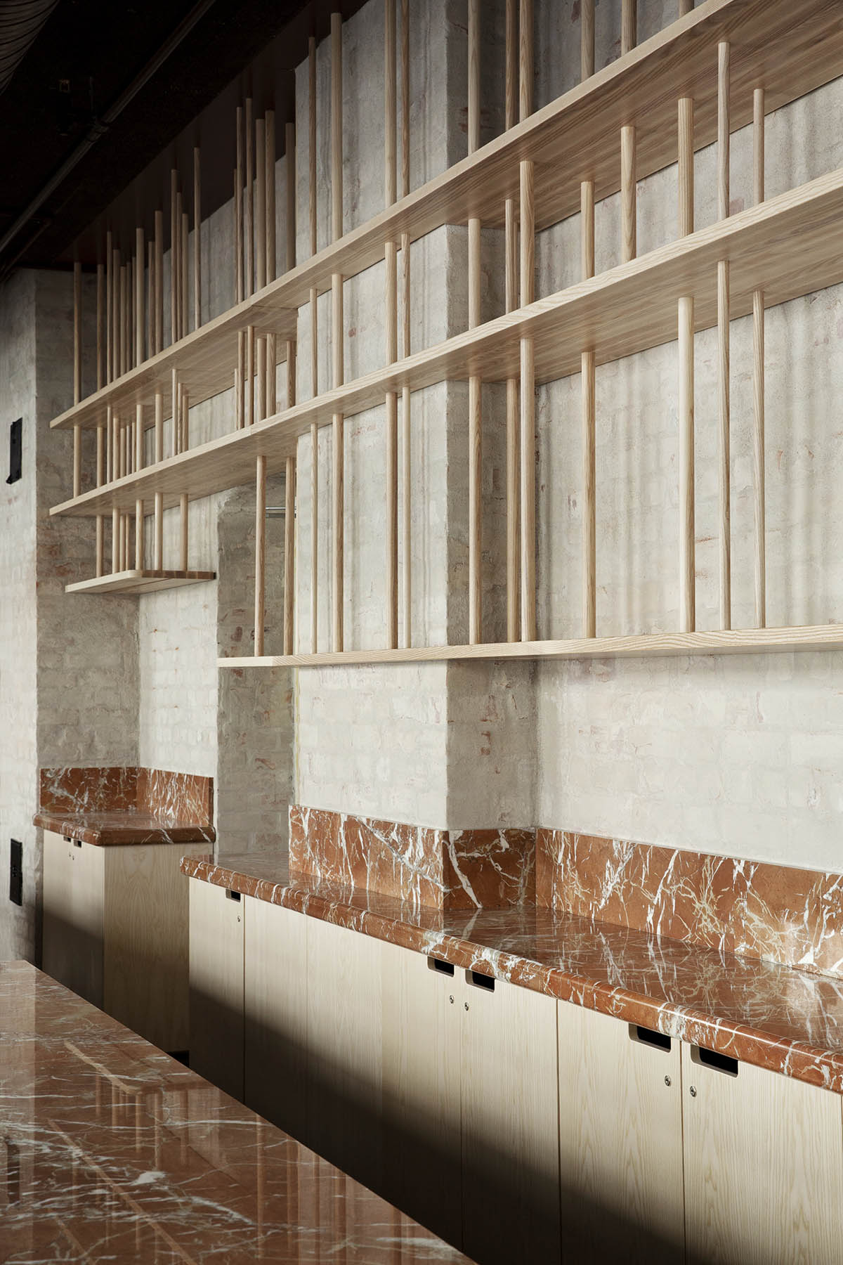 Atelier Oslo and KIMA Arkitektur restore former warehouse as a press house with light-lit atrium