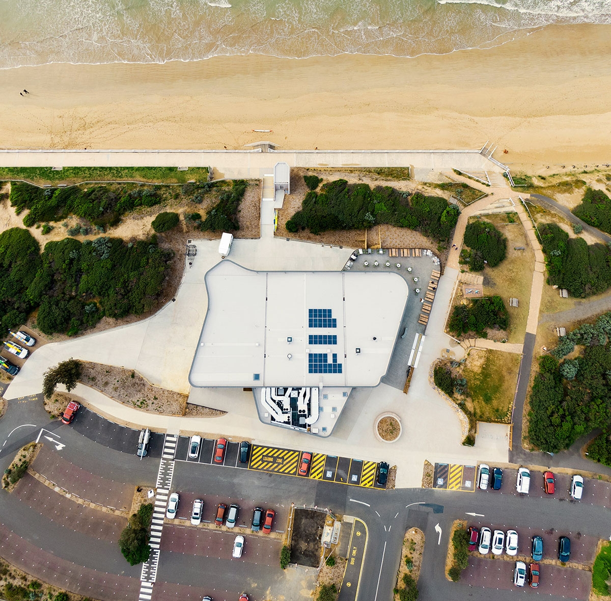 Wood Marsh completes surf club with timber rounded corners echoing ocean and eroded dunes