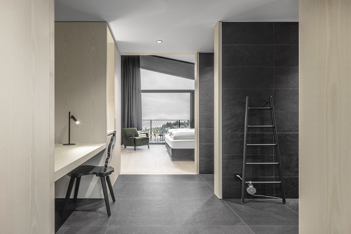 Peter Pichler's Hotel Milla Pontis features black exoskeleton inspired by vernacular architecture