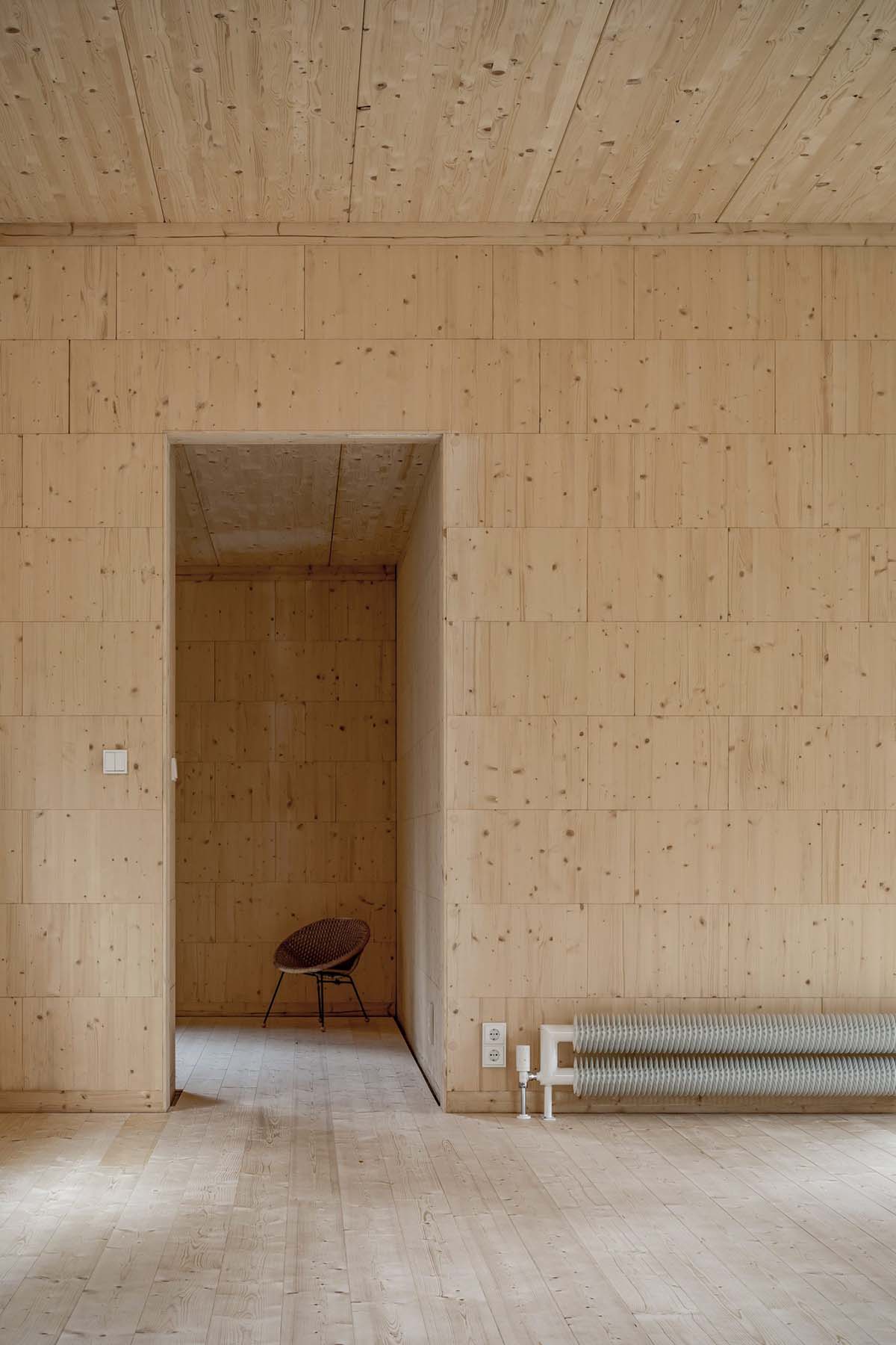 Zeller & Moye built private residence composed of interlocked timber cabins among pine trees