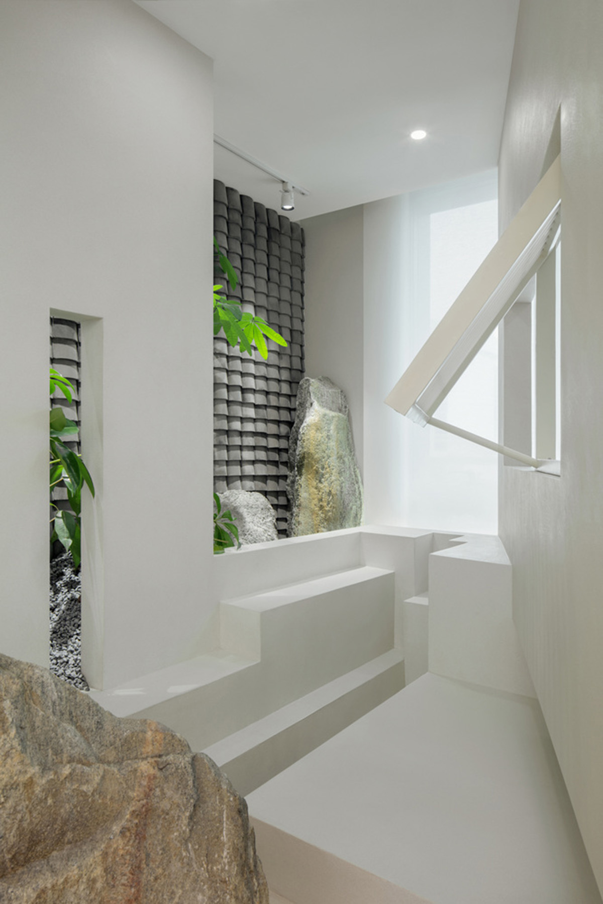 Jiejie studio wraps this tea room with a peach garden with rocky and forest landscape in Beijing