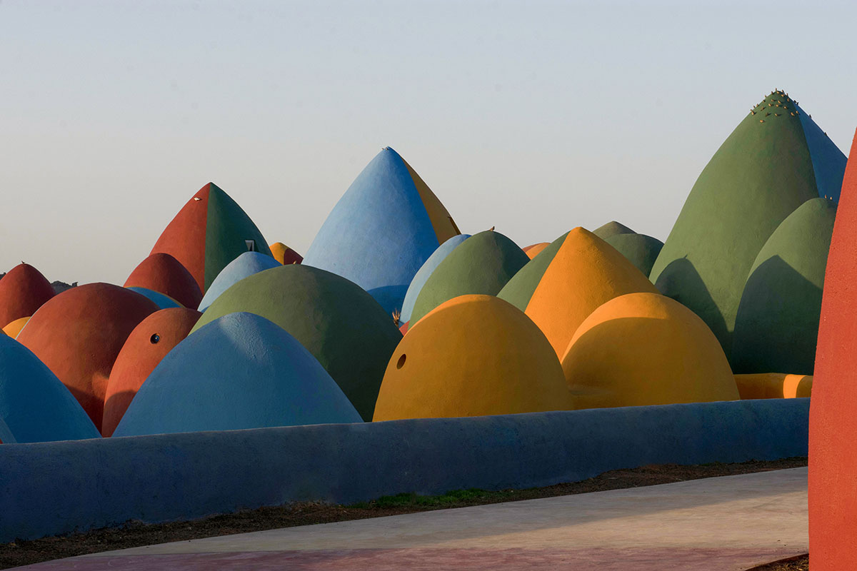 ZAV Architects built colorful-domed housing made of rammed earth and sand on Hormuz island, Iran