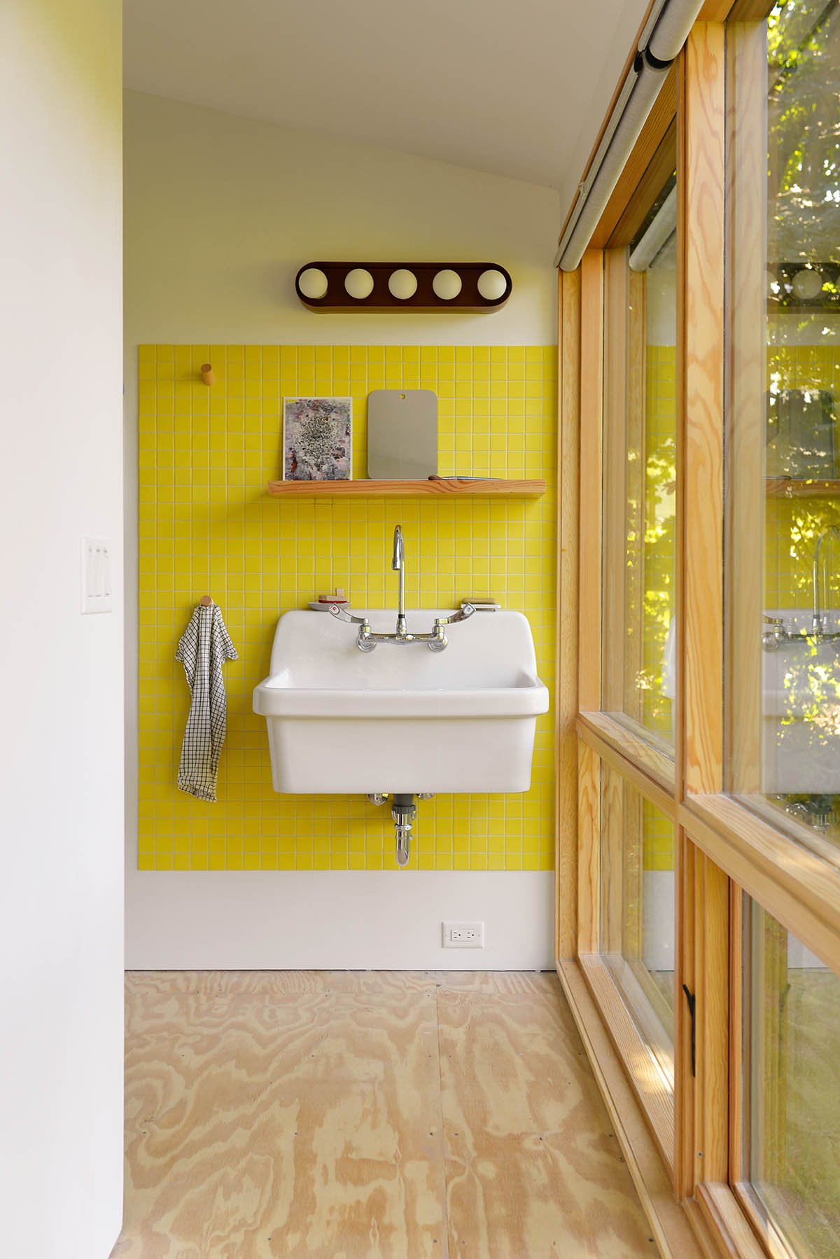 An artist's studio floats and illuminates in the landscape in Germantown