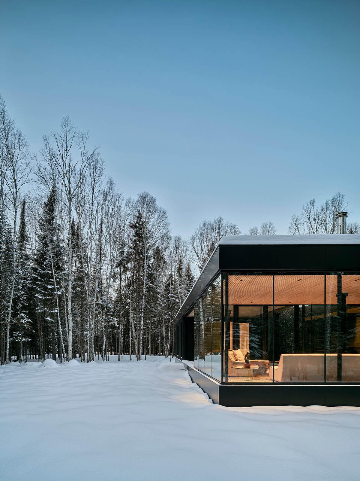 ACDF Architecture built a family glass house around an apple tree in Quebec