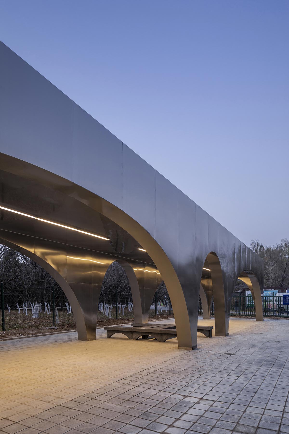 TEMP designs runner's station with stainless steel arcades in Beijing Olympic Forest Park