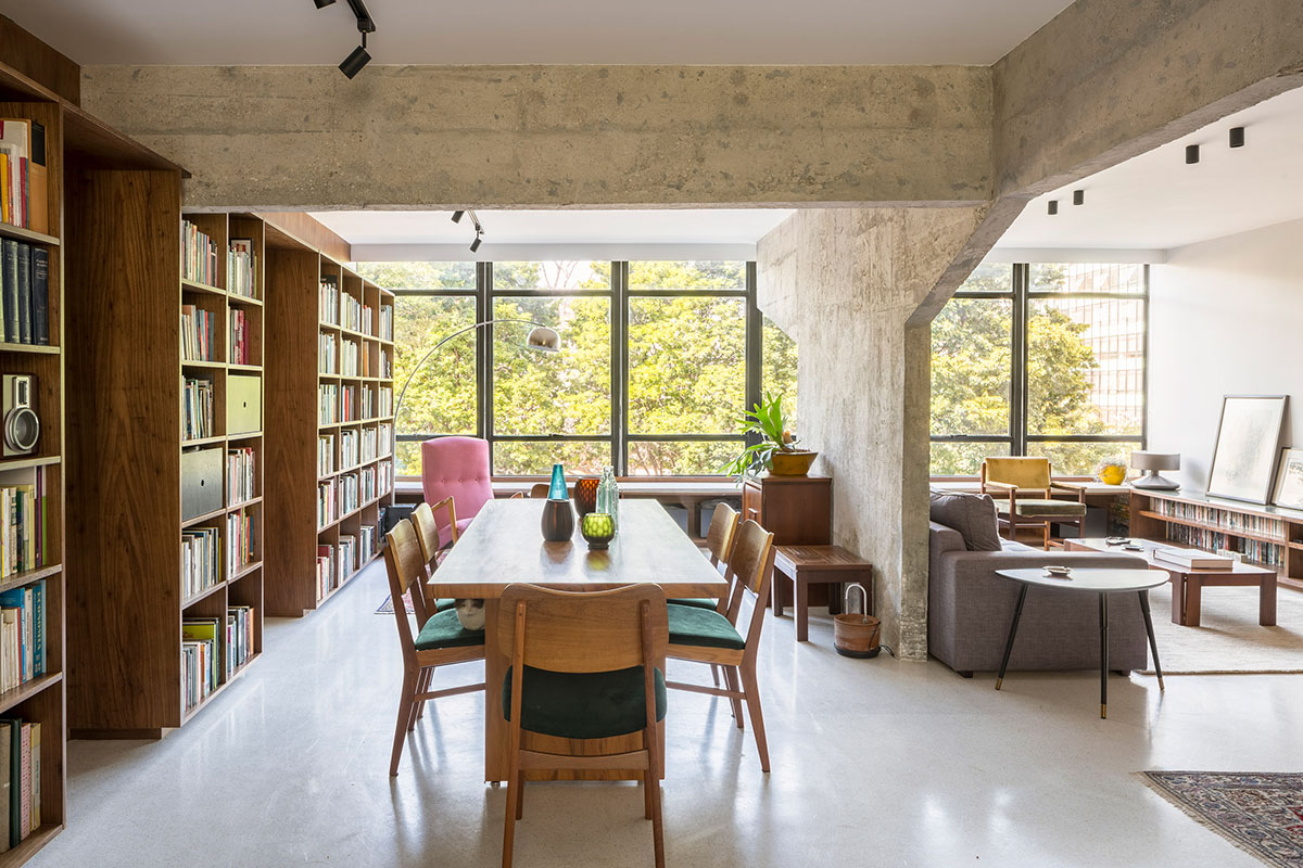 A historic Brazilian apartment has been redesigned with wooden bookcase as main divider
