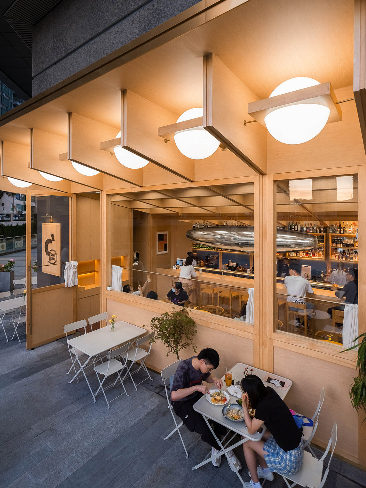 Various Associates completes C² Cafe & Bar in Shenzhen with wooden ceiling details