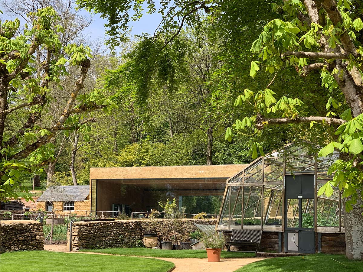 Invisible Studio creates large window for a gymnasium overlooking to a productive garden in Somerset