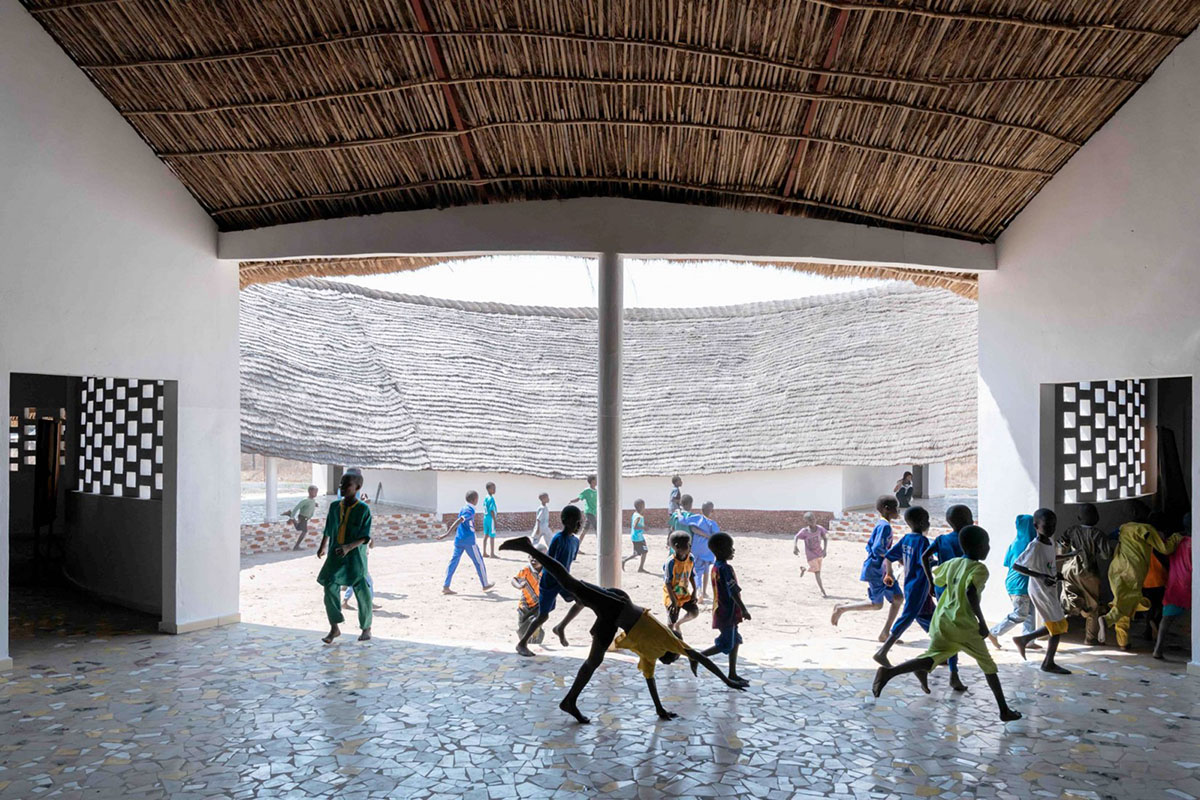 Toshiko Mori built Fass School and Teachers’ Residence featuring wavy thatched roof in remote Senegal