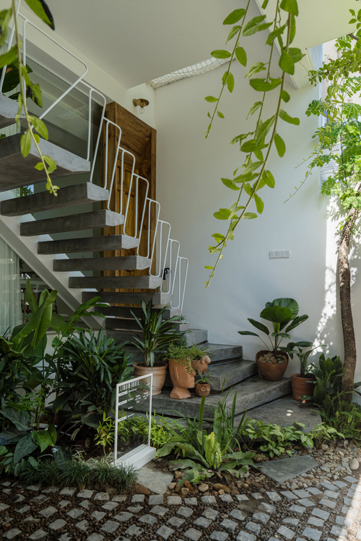 Jalousie House in Vietnam features porous wall with folding pattern for airy interior