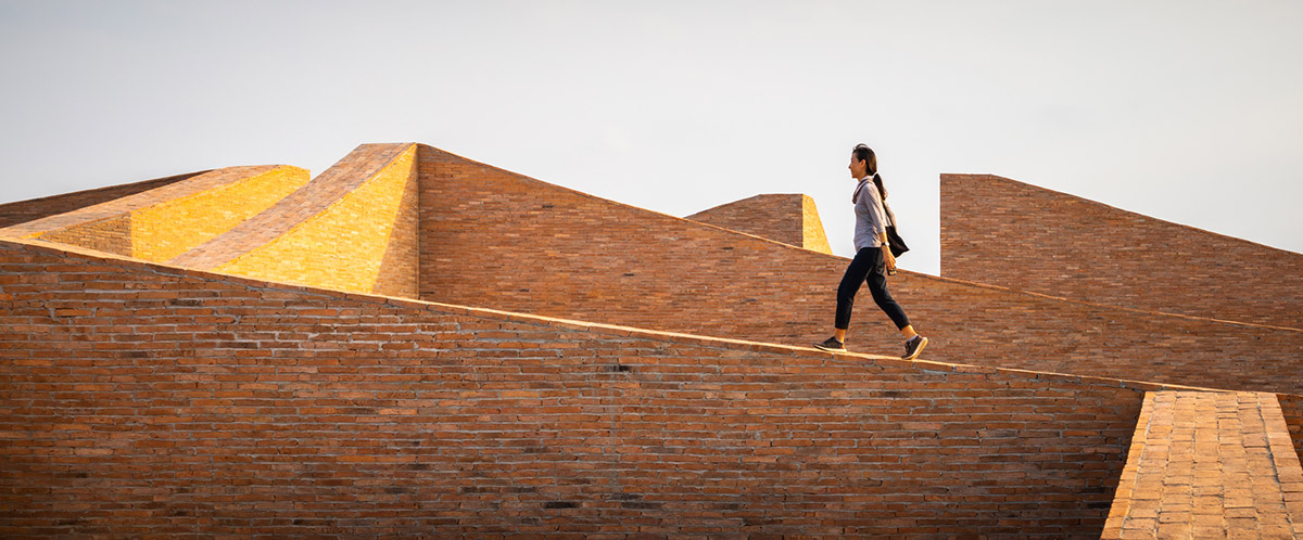 Bangkok Project Studio used over 480,0000 fired clay bricks to form elephant museum with curved walls