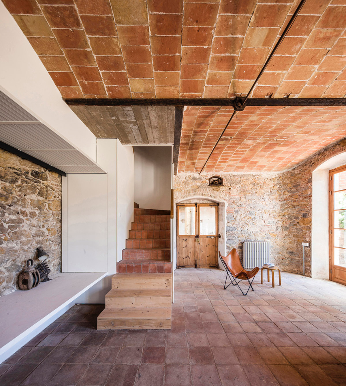 Anna & Eugeni Bach converts former chocolate factory into residence with stone walls in Spain