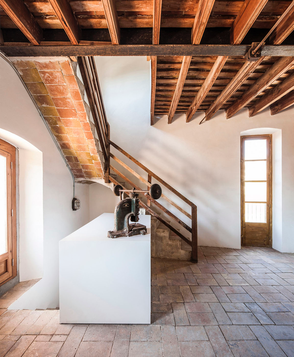Anna & Eugeni Bach converts former chocolate factory into residence with stone walls in Spain
