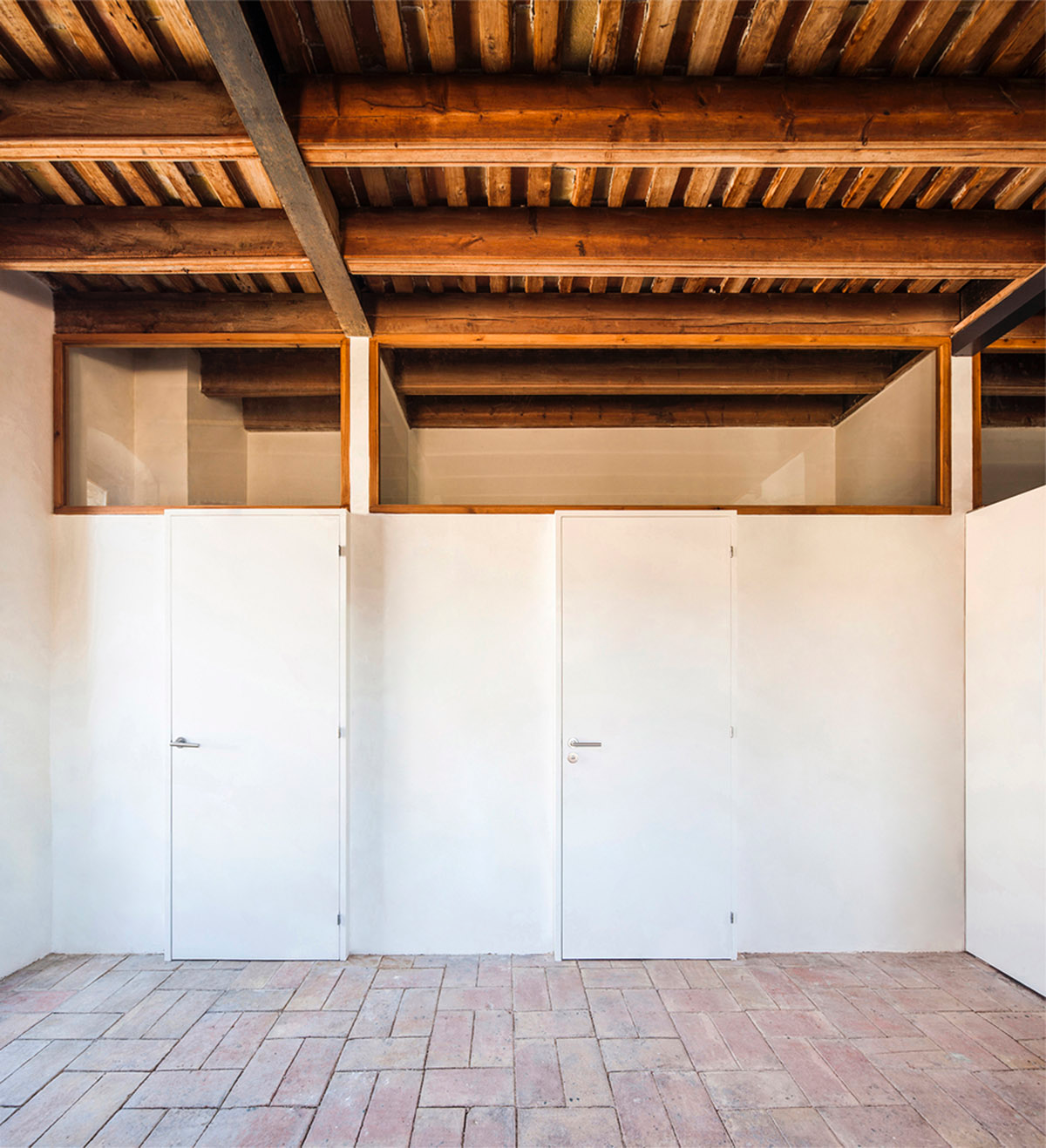 Anna & Eugeni Bach converts former chocolate factory into residence with stone walls in Spain