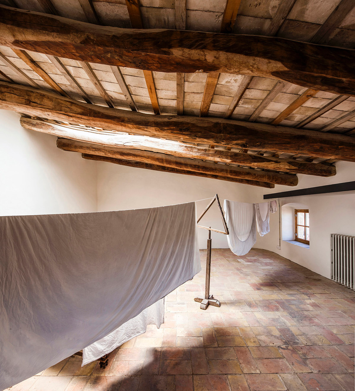 Anna & Eugeni Bach converts former chocolate factory into residence with stone walls in Spain