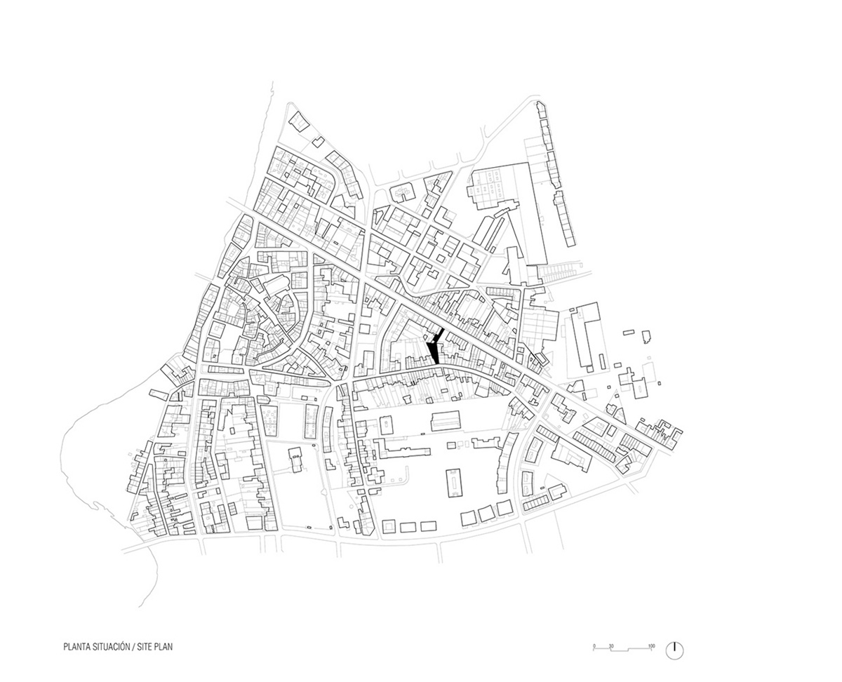 Anna & Eugeni Bach converts former chocolate factory into residence with stone walls in Spain