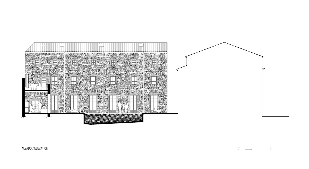 Anna & Eugeni Bach converts former chocolate factory into residence with stone walls in Spain