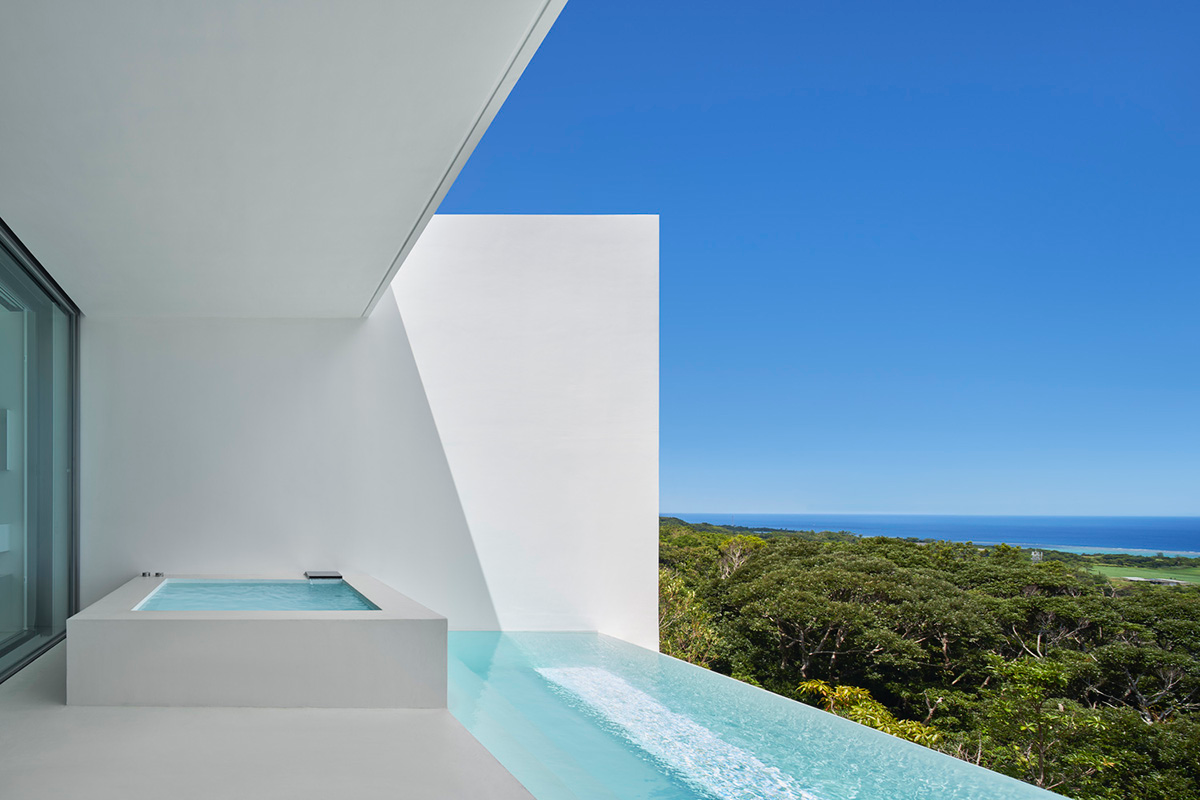 Shinichi Ogawa & Associates hides five guest rooms within all-white minimalist volume in Japan