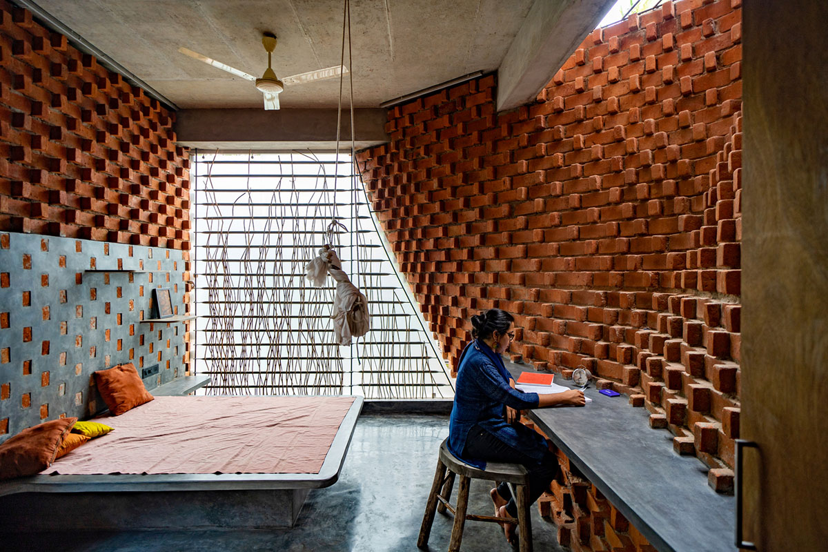 Wallmakers create slanting brick walls for Pirouette House in India to create larger interior spaces
