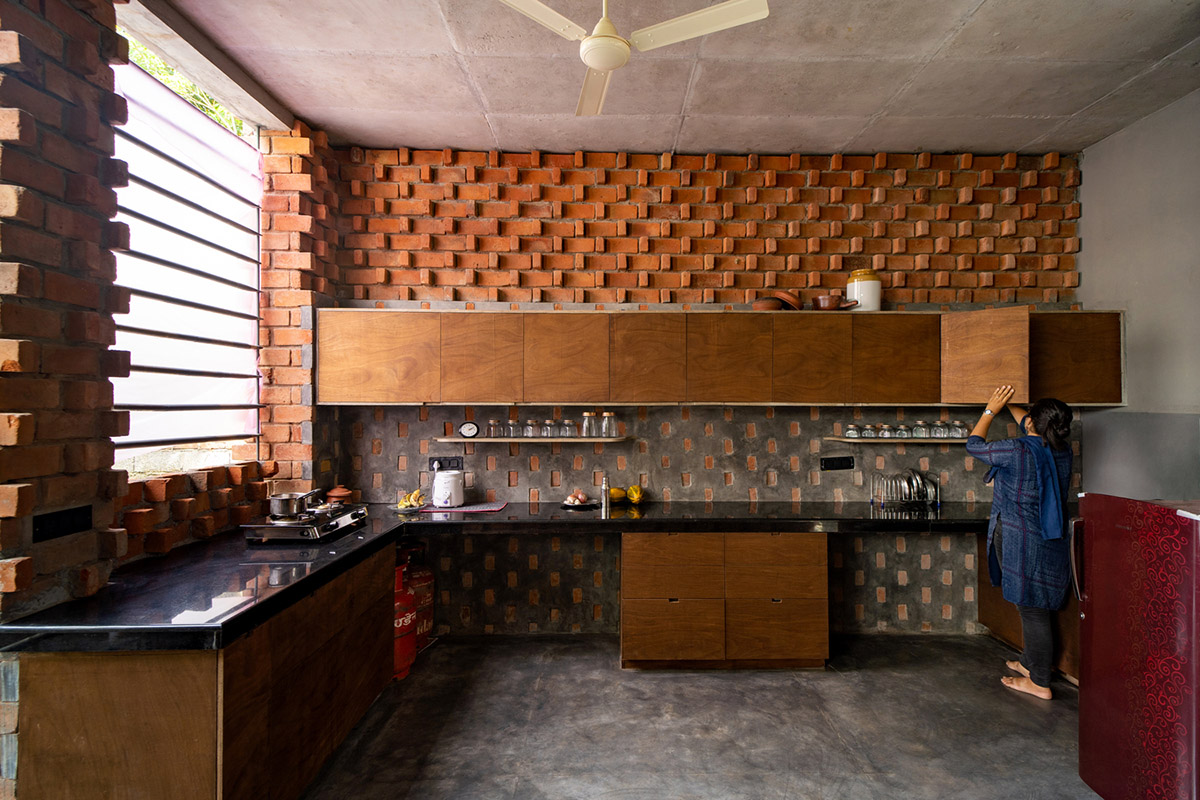 Wallmakers create slanting brick walls for Pirouette House in India to create larger interior spaces