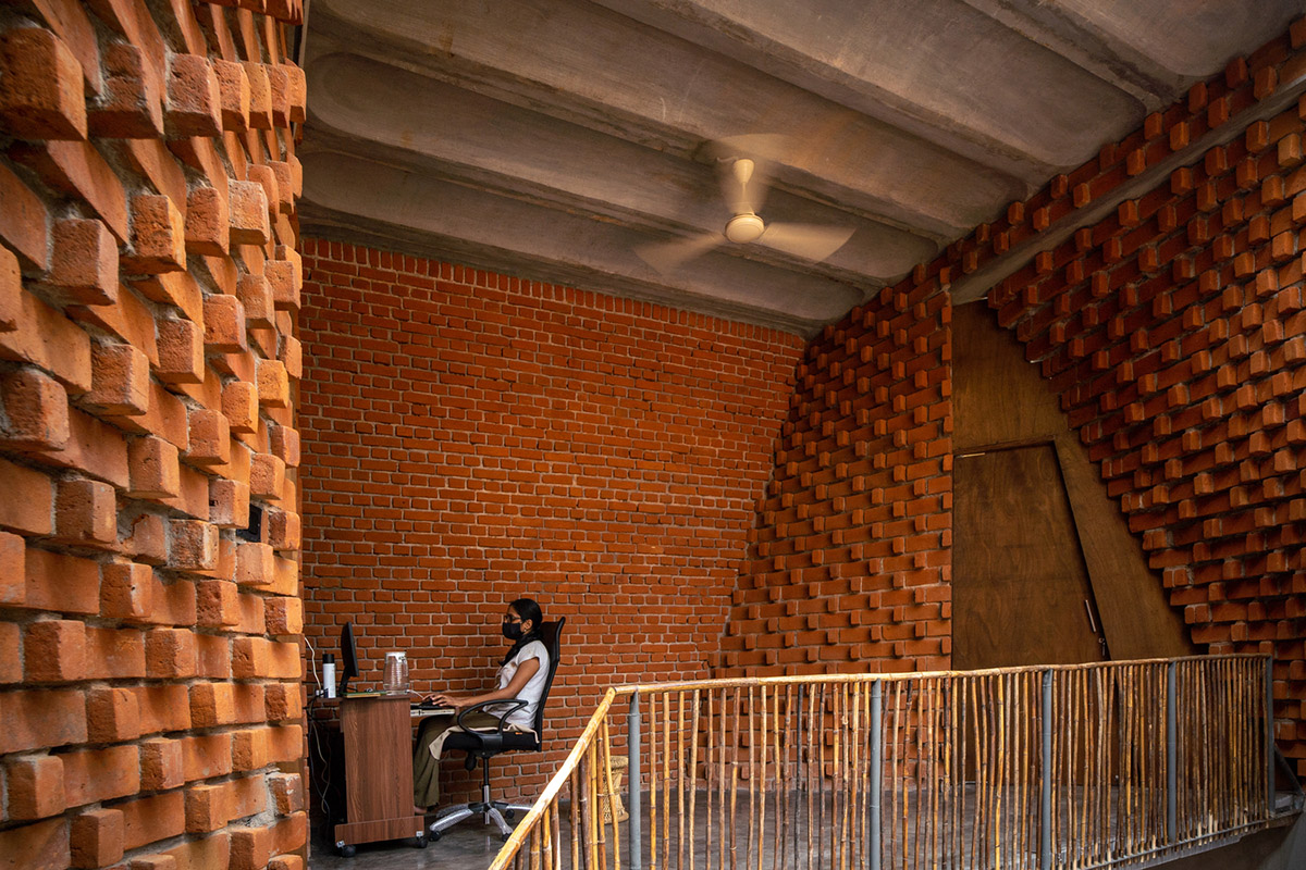 Wallmakers create slanting brick walls for Pirouette House in India to create larger interior spaces