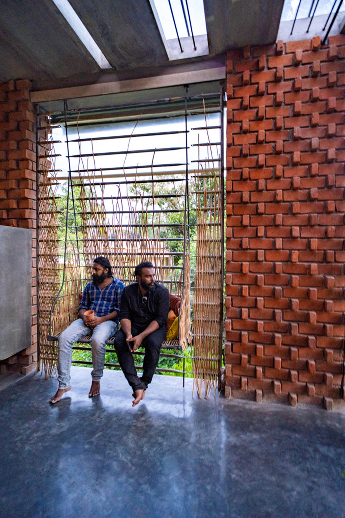 Wallmakers create slanting brick walls for Pirouette House in India to create larger interior spaces