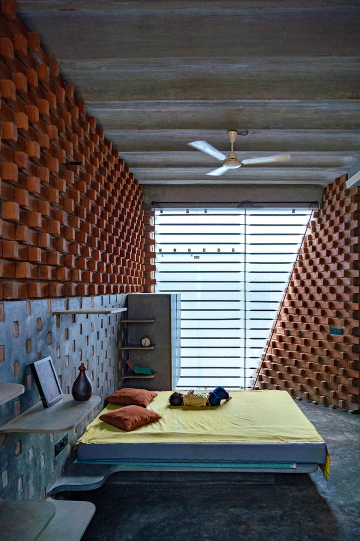 Wallmakers create slanting brick walls for Pirouette House in India to create larger interior spaces