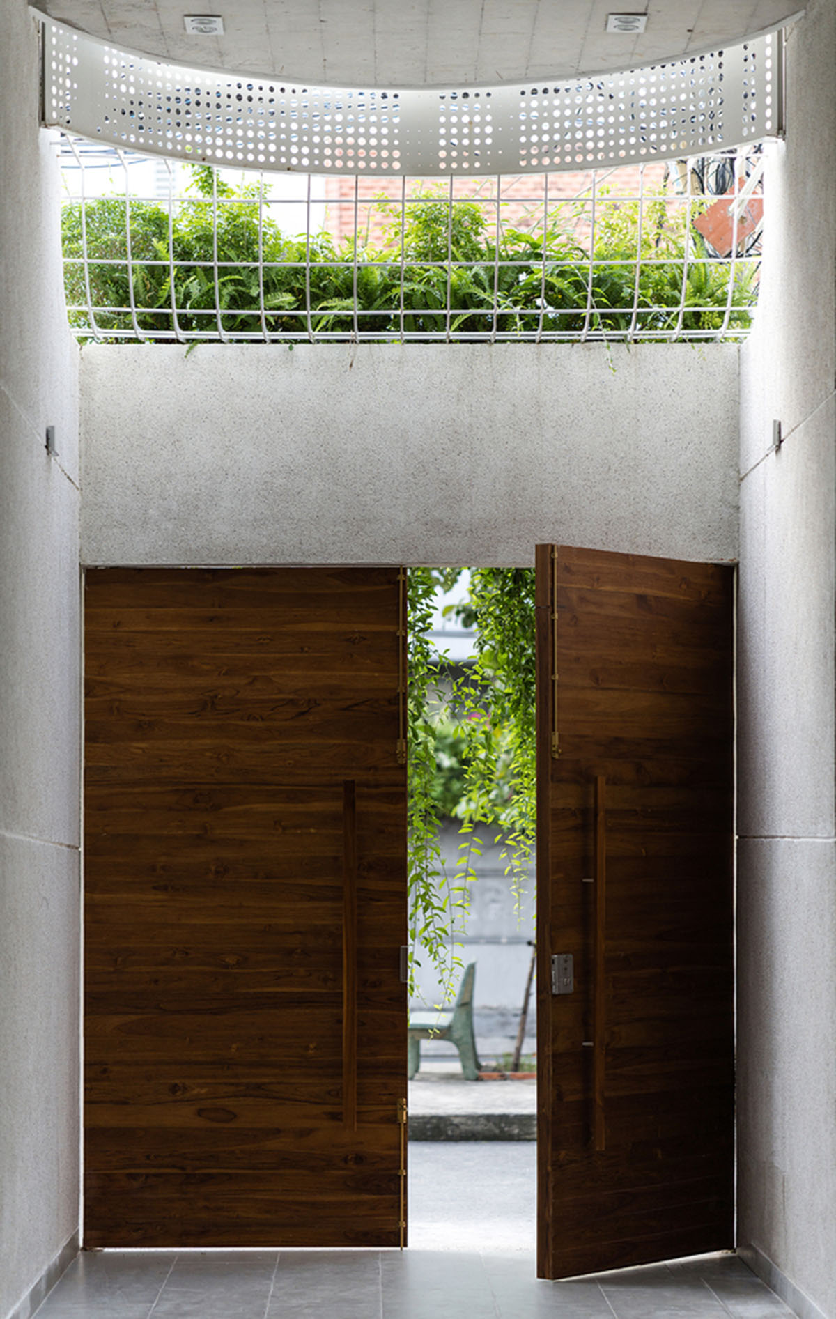 AD9 Architects built residence on a narrow plot with half-circled balconies in Vietnam