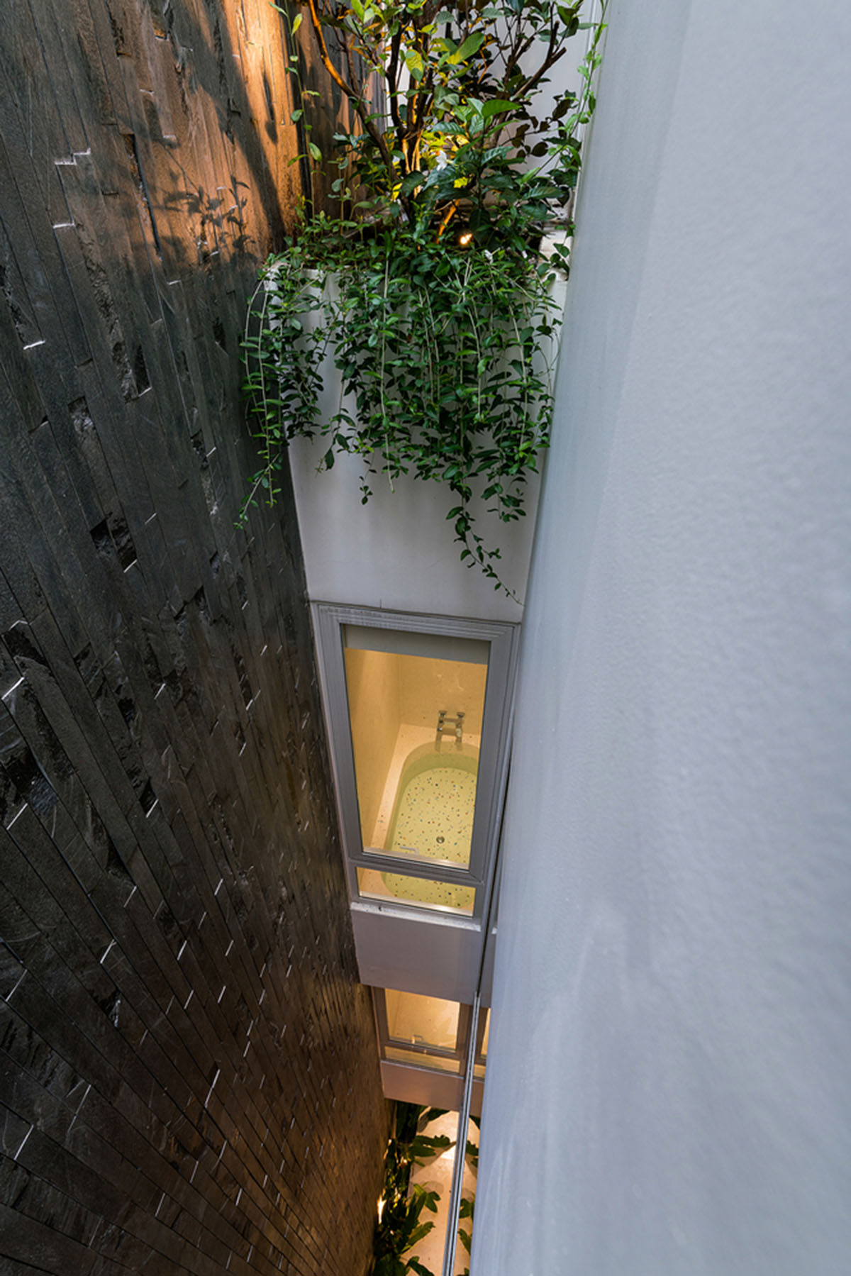 AD9 Architects built residence on a narrow plot with half-circled balconies in Vietnam